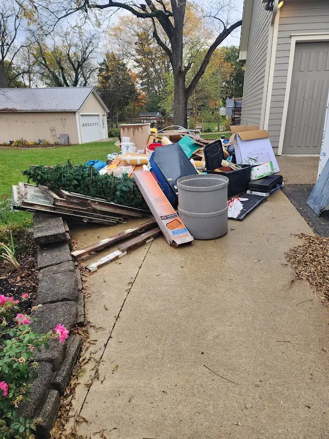 Dumpster being loaded with debris for Estate Cleanout Dumpster Rental in Scottsburg